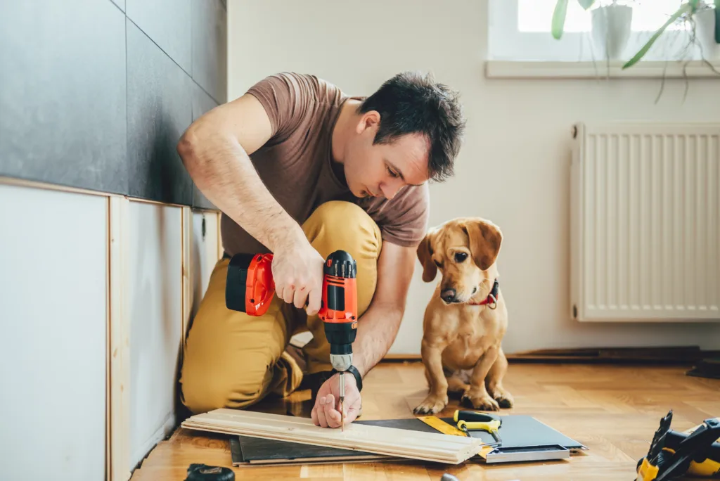 man making a dog dish stand with dog watching