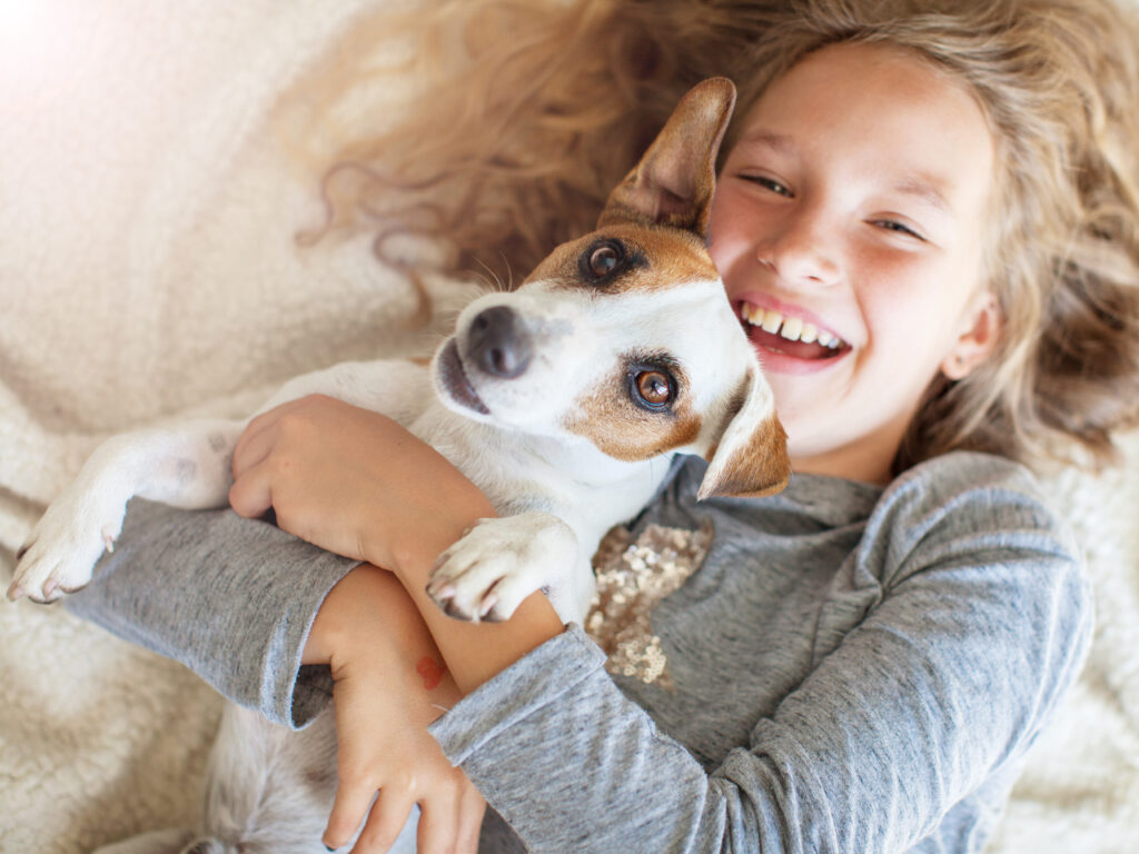 cute girl holding dog